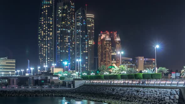 Skyscrapers of Abu Dhabi at Night with Etihad Towers Buildings Timelapse alt
