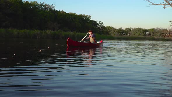 Cowboy in a Canoe Floats on the River alt