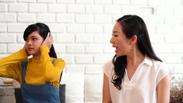 Argument Between Annoyed Asian Teenage Daughter and Upset Middle Aged Mother alt