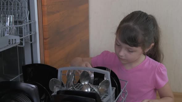 Child with clean dishes.  alt