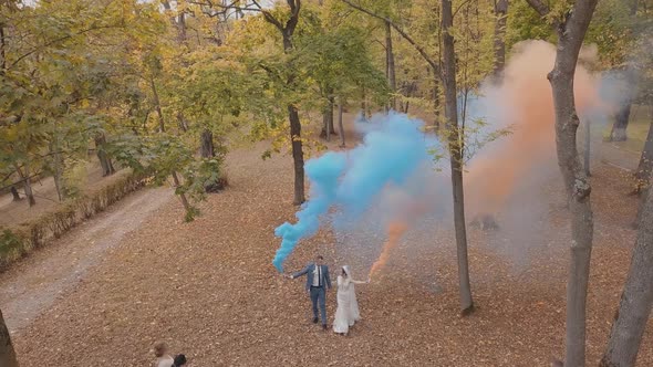 Caucasian Groom with Bride in the Park. Wedding Couple. Smoke Bombs. Newlyweds alt