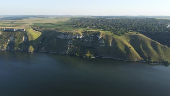 Aerial view of wide Dnister river and distant rocky hills in Bakota area, part of the National park,