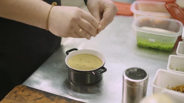 Close Up of Chef Hand Decorating a Cream Soup in the Restaurant