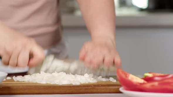 Woman Grinds White Onion