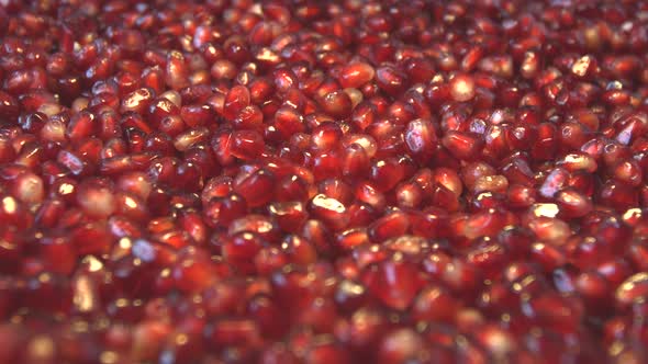 Pomegranate Grains on Brown Wooden Background