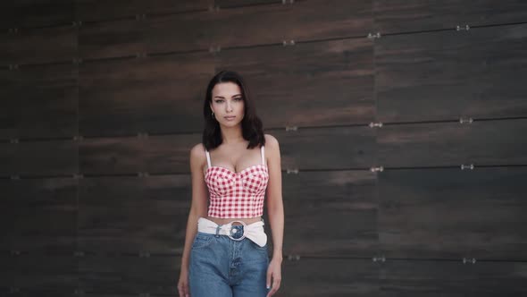 Confident Young Caucasian Beautiful Brunette Model Walks Forward to Camera alt