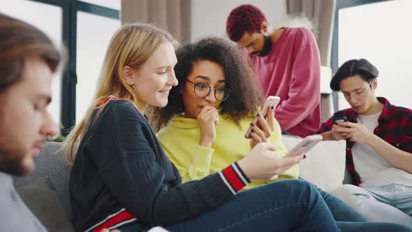 Cheerful Multicultural Young People Students Laughing Talking Having Fun with Gadgets Technology alt