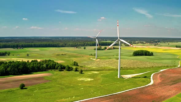 Two wind turbines on green field in summer Poland, aerial view alt