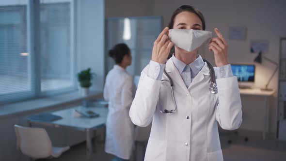 Woman Putting On Mask alt