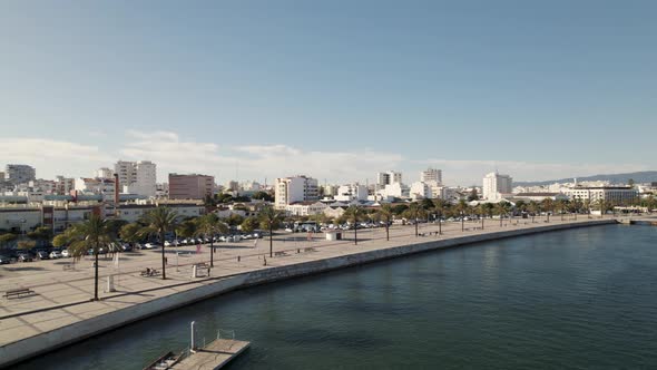 Aerial circle view, cityscape and waterfront of Portimao. Portugal. Slow motion alt