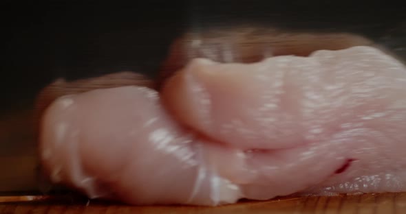 Raw Chicken Fillet Is Cut Into Pieces.  alt