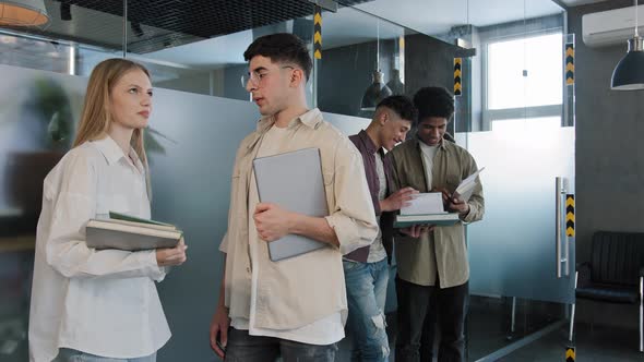 Young Diverse People Students Stand in Corridor Near Classroom Communicate Talking Discussing Topic alt
