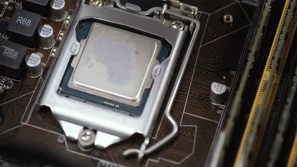Cleaning Old Thermal Paste From the Computer Processor Close Up alt