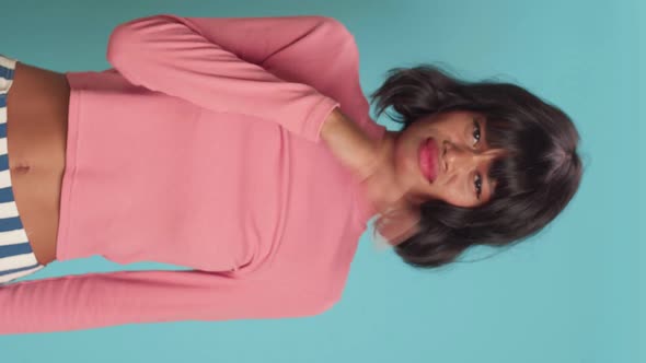 Young Female Waves Hand Near Nose Feels Unpleasant Smell Over Blue Background alt