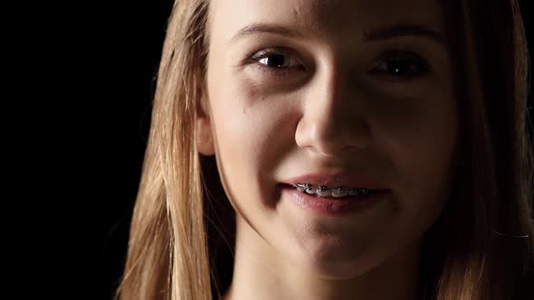 Girl in the Shade with Braces Smiling. Black alt