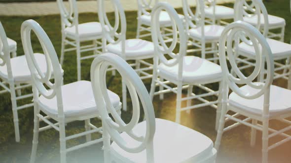 White Chairs for Guests at a Wedding Ceremony Slow Motion alt