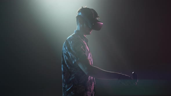 Male Gamer In VR Headset Using Controller alt