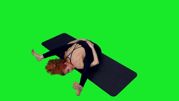 Athletic Woman Doing Yoga Exercises On Mat Against Green Screen