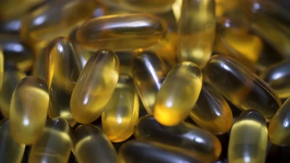 Supplement vitamin gel capsule omega 3 rotation on black mirror surface alt