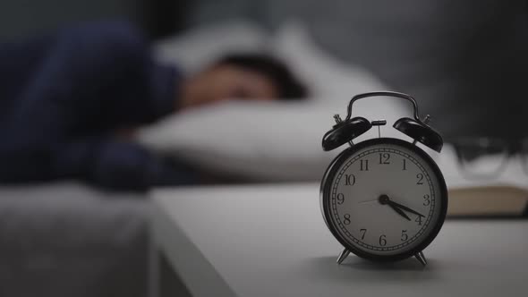Woman Sleeping Near Clock