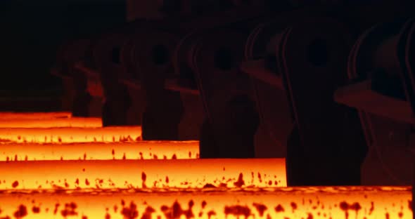 Iron foundry. Continuous casting machine. Steel billet moving through the pipeline.
