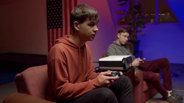 Nervous Young Man with Gamepad Playing Videogame