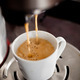 Coffee maker pouring hot espresso coffee in a cup - PhotoDune Item for Sale