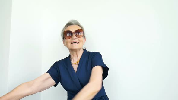 Female Portrait of Beautiful Old Grandmother with Grey Hair and Face with Wrinkles Making Dab on alt