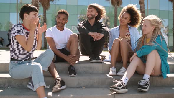 Cool Young Diverse Friends Chilling on Street alt