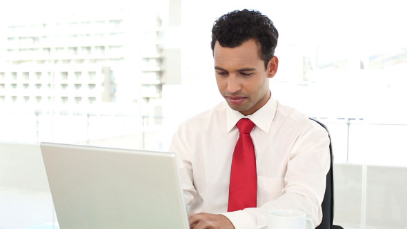 Cheerful Handsome Businessman Typing On Laptop