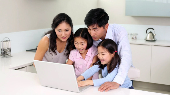 Happy Family Using Laptop Together