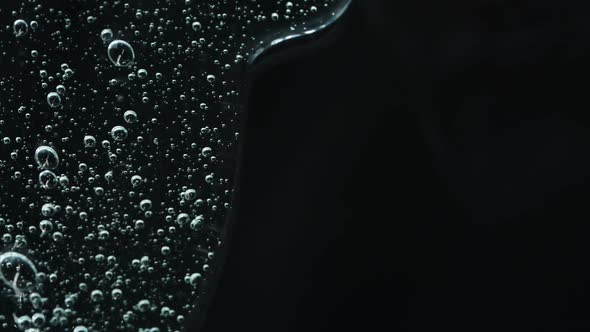 Cosmetics Serum Fluid Gel Hyalurinic Acid Cream Texture on Black Background