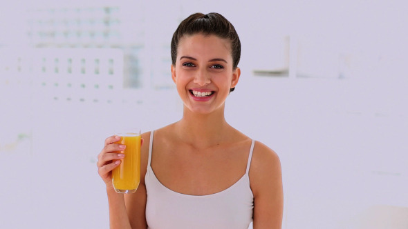 Joyful Beautiful Woman Enjoying Orange Juice