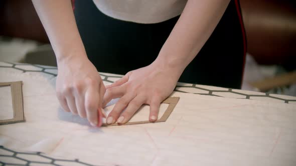 Young Woman Seamstress Making Marks Using the Soap and Form Indoors alt