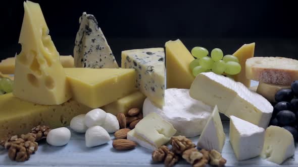Assorted Different Types of Cheeses with Fruits, Nuts, Dried Fruits