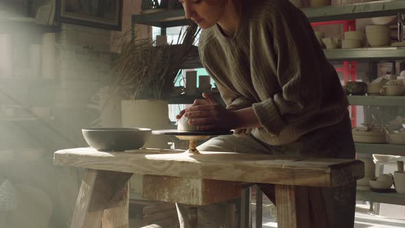 Woman Potter Is Putting Piece of Clay On Potter's Wheel alt