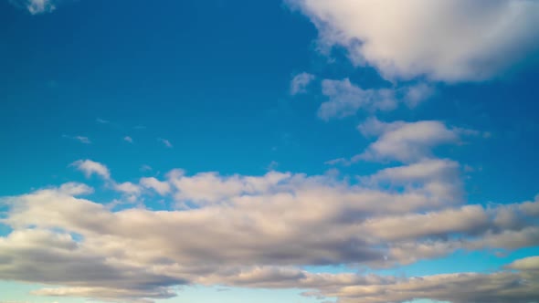 Timelapse of Blue Sky with Floating or Flying White Clouds alt