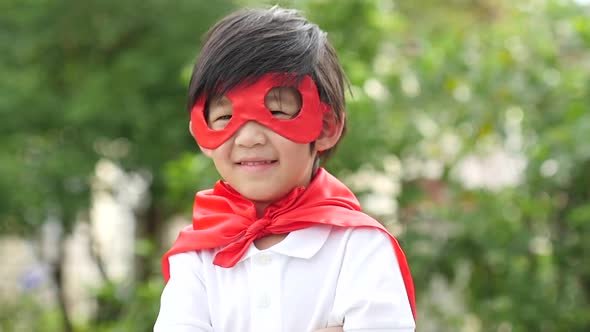 Asian Child In In Superhero Costume Playing In The Park Slow Motion alt