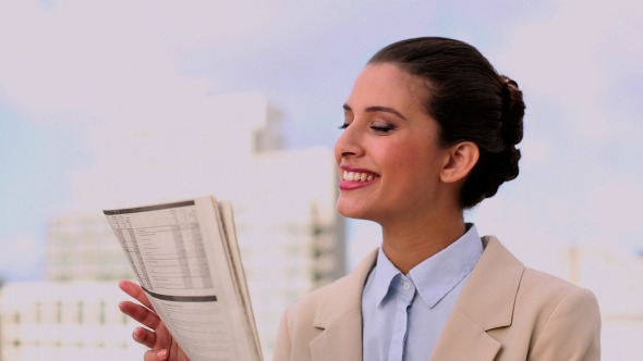 Delighted Beautiful Businesswoman Reading News