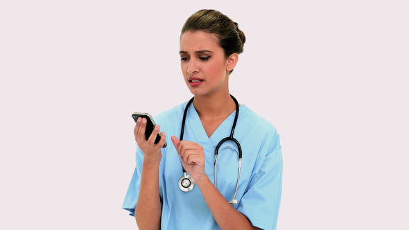 Thoughtful Beautiful Nurse Using A Mobile Phone