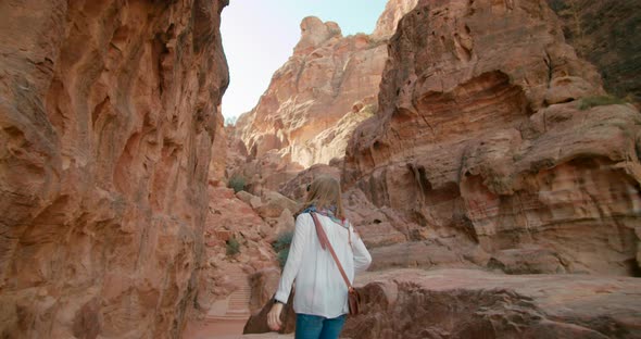 Tourist Woman Visits Petra Taking Photo of Ancient Red Rode City in Jordan