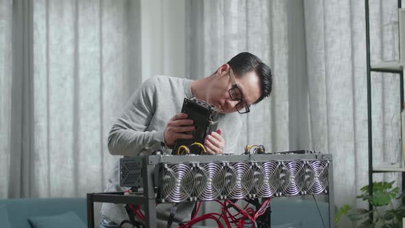 Asian Man Wearing Glasses Build The Mining Rig For Mining Cryptocurrency alt