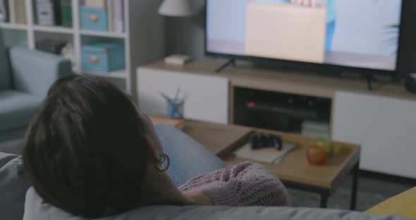 Woman watching an unboxing video on her television
