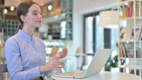 Video Chat on Laptop By Young Businesswoman in Cafe alt