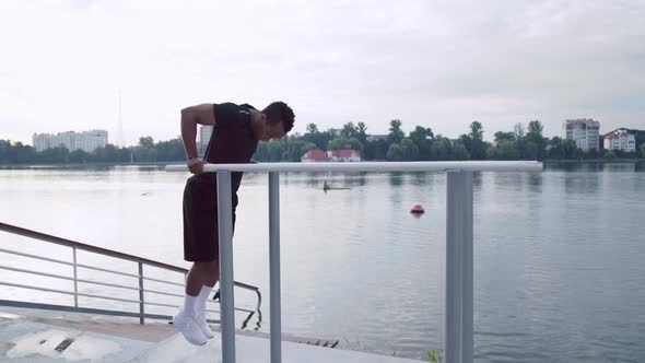 Side View of African Man Doing Triceps Dip Exercise alt