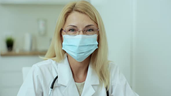 Close Up Portrait of Family Medical Doctor with Glasses is in Health Clinic alt