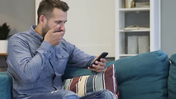 Shocked, Astonished Man Using Smartphone alt