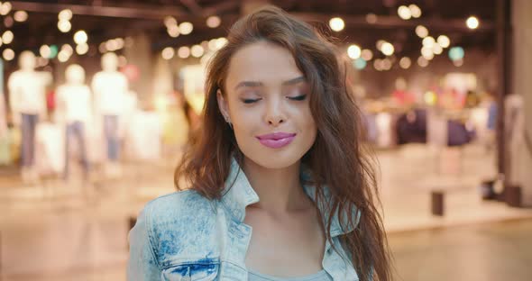 The Woman is Turning Her Head and Looking at the Camera alt