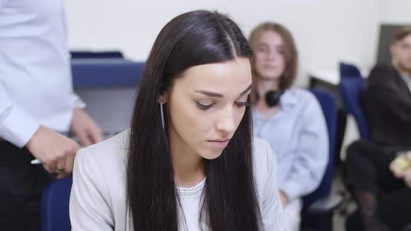Embarrassed Young Woman Sitting in Office Working As Unrecognizable Man Putting Hand on Shoulder alt