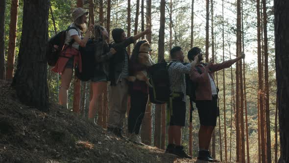 Portrait of Creative Young People Tourists Taking Selfie with Smart Phone Camera in Green Forest alt